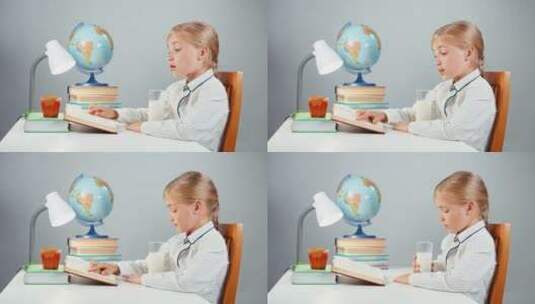 喝牛奶看书的小女孩高清在线视频素材下载