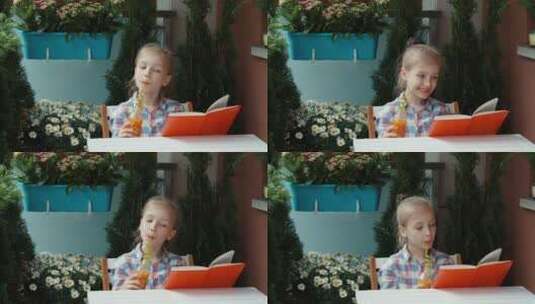 女孩喝着果汁读书高清在线视频素材下载