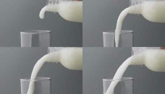 慢镜头拍摄瓶中牛奶饮品倒入玻璃杯高清在线视频素材下载