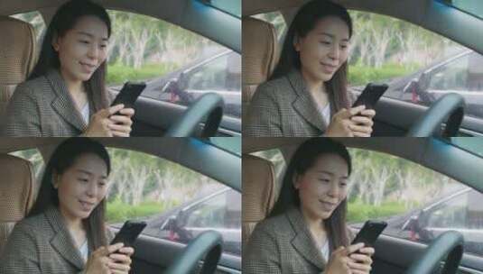 中国女性美女阴天开车车内玩手机高清在线视频素材下载