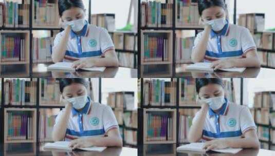戴口罩的初中生坐在学习图书馆看书学习4k高清在线视频素材下载