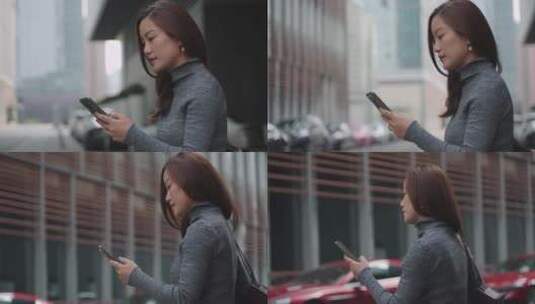 自信美女职业女性走在城市街头看手机高清在线视频素材下载