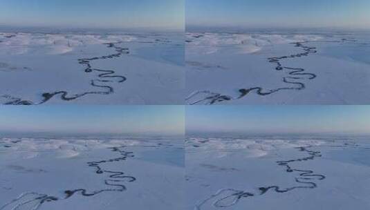 航拍雪原上蜿蜒的冰封河流暮色高清在线视频素材下载