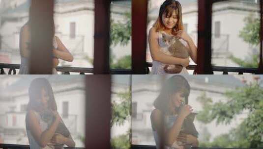 女孩阳台抱猫高清在线视频素材下载