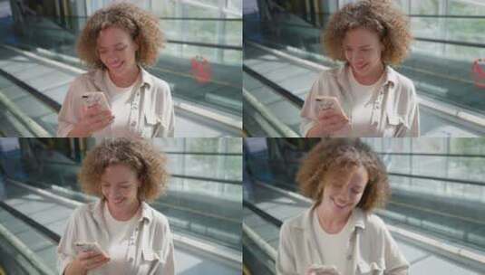 女人靠在电梯围栏上玩手机高清在线视频素材下载