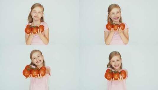 小女孩捧着西红柿微笑高清在线视频素材下载