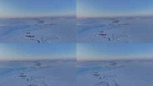 航拍雪原上蜿蜒的冰封河流暮色高清在线视频素材下载