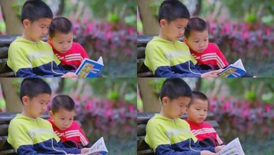 两个小朋友在公园长椅看漫画书高清在线视频素材下载