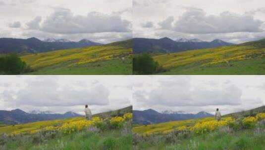 美女走在花丛草地中山间小路高山山脉白云高清在线视频素材下载
