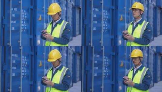 中年男人工程师在商业港口集装箱码头用手机高清在线视频素材下载