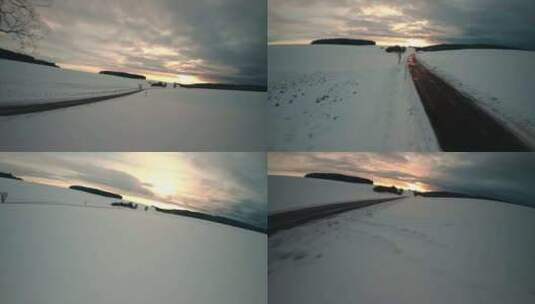 FPV无人机航拍汽车行驶雪地公路森林阳光高清在线视频素材下载