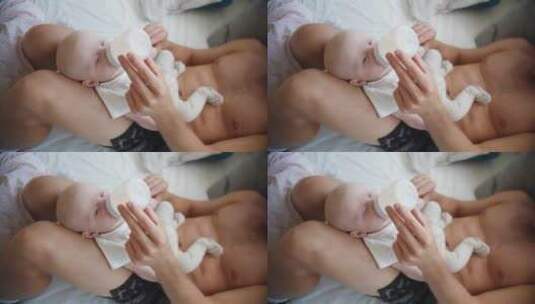 一个男人正在给婴儿喂奶高清在线视频素材下载
