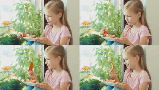 女孩嗅着红色甜椒在镜头前点头微笑高清在线视频素材下载