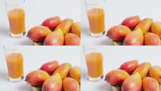 白背景的新鲜芒果与果汁4k视频高清在线视频素材下载