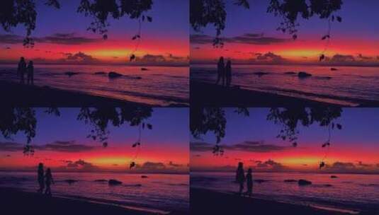夕阳余晖下情侣牵手散步在沙滩高清在线视频素材下载
