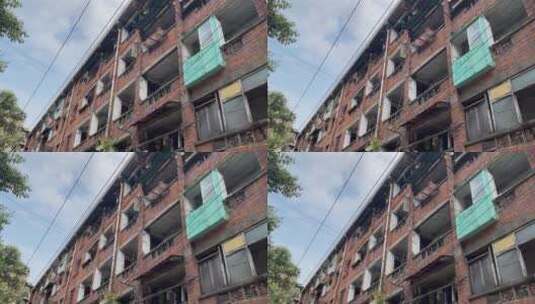 仰视红砖居民楼树叶窗台晾衣服杂物市井生活高清在线视频素材下载