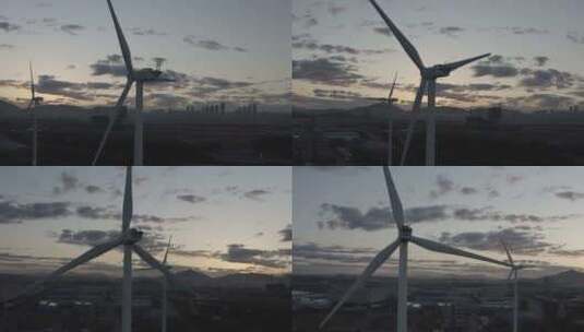 黎明时分，城市周围有两台风力发电机。高清在线视频素材下载