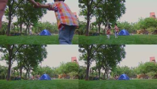 两个孩子在草地上手拉手开心奔跑回头看高清在线视频素材下载