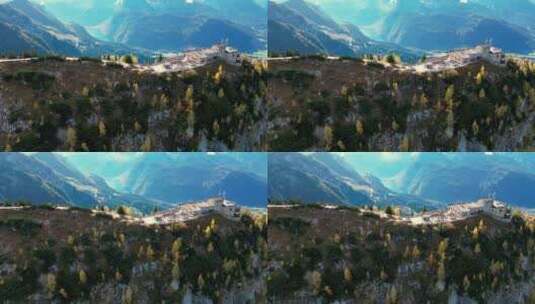一座石头堡垒坐落在崎岖的山顶上，俯瞰着翡高清在线视频素材下载