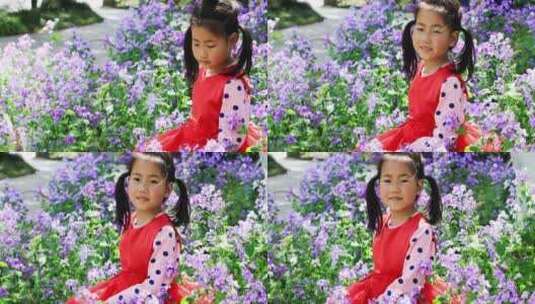 二月兰花丛里微笑的可爱小女孩高清在线视频素材下载
