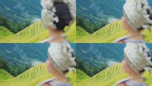 少数民族服饰/少数民族女生站在水稻田高清在线视频素材下载