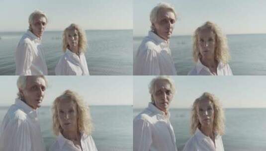 情侣穿白衬衫在海岸看镜头高清在线视频素材下载