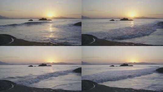 海边夕阳日落，海浪冲击沙滩和礁石带声音高清在线视频素材下载