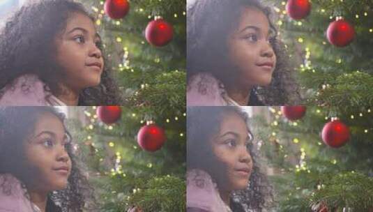 小女孩看着圣诞树微笑高清在线视频素材下载