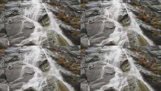 瀑布从山崖边的岩石上倾泻而下高清在线视频素材下载