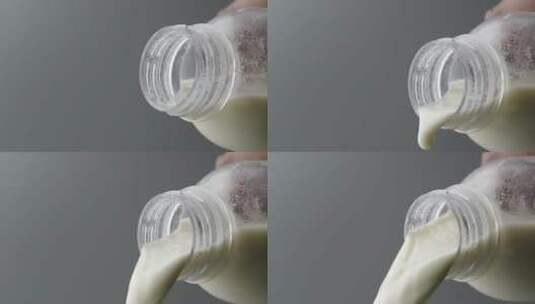 慢镜头特写拍摄瓶口倾倒中的牛奶高清在线视频素材下载