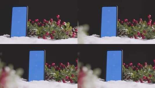 圣诞节背景上的蓝屏手机和浆果高清在线视频素材下载