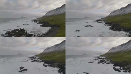 冰岛海岸格陵兰海岩石海岸上空的空中运动，绿草如茵高清在线视频素材下载