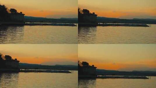 金色的日落在湖上，平静的水慢慢移动，橙色的天空。放松的情感时刻。高清在线视频素材下载