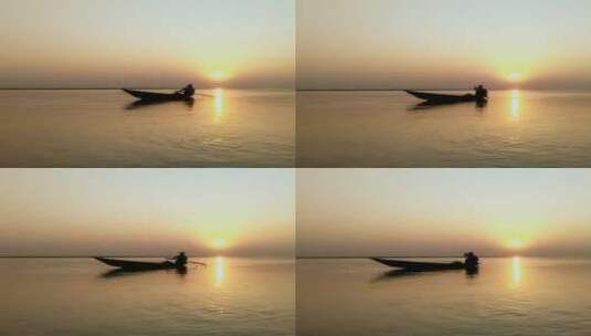 日落时分船上一个男人的剪影高清在线视频素材下载