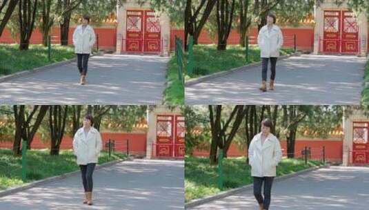秋天走在北京地坛公园红墙外的中国女性高清在线视频素材下载
