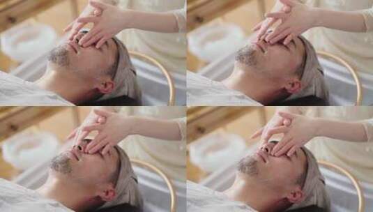 spa会所美女技师为男性客户做头部保健高清在线视频素材下载