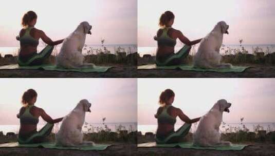 一个年轻的女人和她的狗在海边冥想高清在线视频素材下载