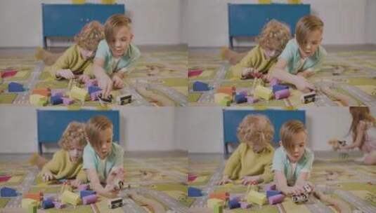 两个小朋友趴在地板上玩积木高清在线视频素材下载