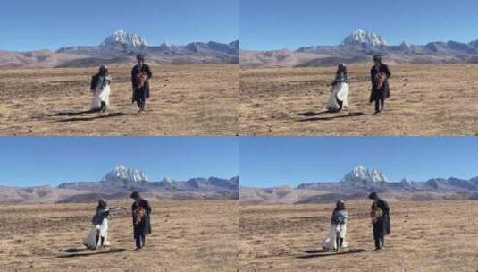 高原枯黄草原雪山情侣奔跑慢动作拍写真婚纱高清在线视频素材下载