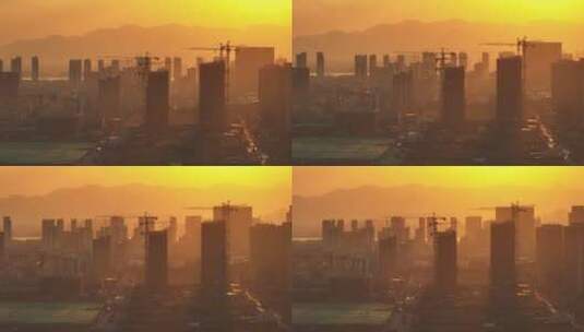 夕阳下建设开发中的城市建筑工地塔吊剪影高清在线视频素材下载