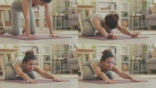 在家瑜伽练习中以儿童姿势躺着的女人高清在线视频素材下载