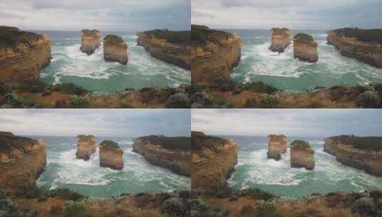 航拍海浪在暴风雨前撞击荒岛的岩石悬崖。高清在线视频素材下载
