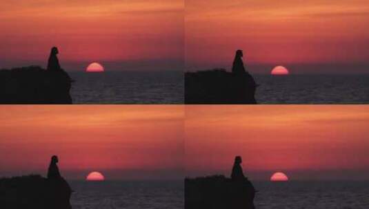 孤独的女生坐在悬崖海边看夕阳高清在线视频素材下载