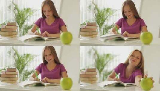 正在写作业的小女孩拿起青苹果高清在线视频素材下载