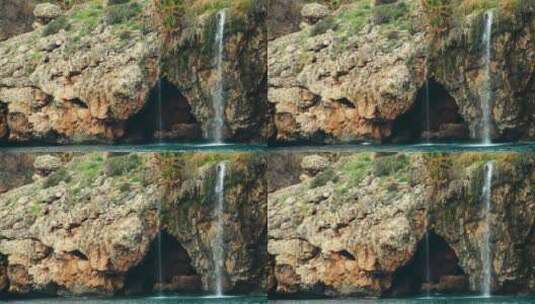 海边岩石海岸线上的瀑布高清在线视频素材下载