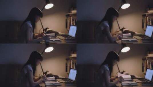 女孩夜晚在书桌台灯下写字学习视频素材高清在线视频素材下载