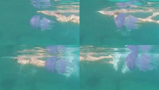 一个年轻美丽的女子在水下慢动作拍摄高清在线视频素材下载