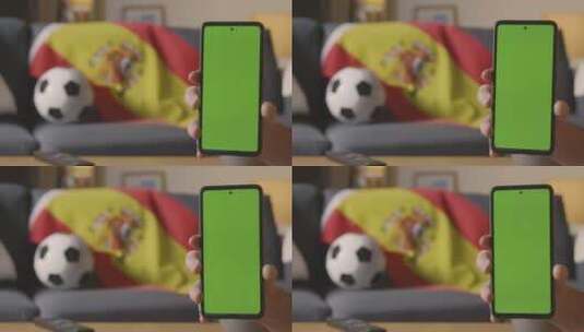 西班牙国旗和足球前的绿屏手机高清在线视频素材下载