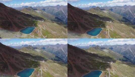 一个阳光明媚的夏日，奥地利阿尔卑斯山一个山湖的航拍镜头，只有一些绒毛高清在线视频素材下载