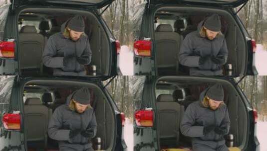 冬季坐在汽车后备箱的男人高清在线视频素材下载